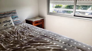 Older woman and partner in a rumpled bedroom scene