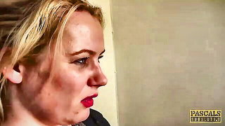 Older couple laughing together on a rumpled bed