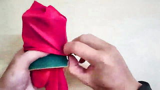 Still from Unwrapping red gift box tutorial, older woman sex video
