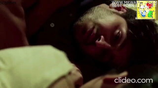 Older woman and partner in a rumpled bedroom scene