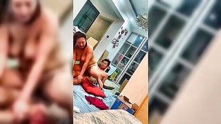 Older couple laughing together on a rumpled bed