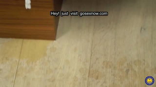 Older couple laughing together on a rumpled bed